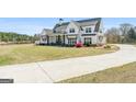 Beautiful two-story home with a long driveway and well-maintained front yard and landscaping at 105 Coogler Way, Brooks, GA 30205