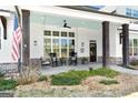 Inviting front porch with swing, rocking chairs, and views into the home's windows at 105 Coogler Way, Brooks, GA 30205