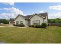 Well-maintained home featuring an attached garage and a nicely landscaped yard with lush greenery at 243 Summergate Ln, Villa Rica, GA 30180