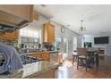 A spacious kitchen features stainless steel appliances, granite countertops, and hardwood floors throughout the open layout at 85 Clairidge Ln, Lawrenceville, GA 30046