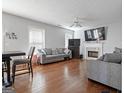 Spacious living room with hardwood floors, a cozy fireplace, and large windows that bring in lots of natural light at 85 Clairidge Ln, Lawrenceville, GA 30046