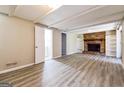 Finished basement with wood-look flooring and a brick fireplace with built-in shelving at 1343 Burbank Trl, Morrow, GA 30260