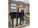 Apartment complex mailboxes stand ready in front of the building with a sign and landscaping at 242 12Th St Ne 1 1A, Atlanta, GA 30309