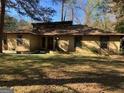 Image featuring the front exterior of the home with a well maintained lawn and stone accents at 1288 Lakewood Ne Dr, Conyers, GA 30013