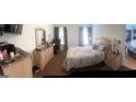 A bedroom with a dresser, television, and a comfortable bed at 122 Lake Ter, Mcdonough, GA 30253