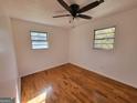 Well-lit bedroom featuring gleaming hardwood floors and a modern ceiling fan at 1433 Butler St, Jonesboro, GA 30236