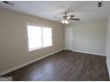 Spacious bedroom with wood-look floors, neutral walls, and a ceiling fan for added comfort at 4242 Timber Valley Ct, Decatur, GA 30032
