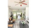 Bright living space showcasing hardwood floors, modern furniture, and an open floor plan connecting to the kitchen and dining area at 1946 Old Dogwood # 31, Jonesboro, GA 30238