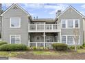 Charming exterior features multi-level balconies, neutral siding, and well-maintained landscaping, enhancing curb appeal at 402 Mill Pond Rd, Roswell, GA 30076