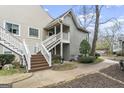 Inviting exterior entrance features a charming stairway leading to the upper level with lovely landscaping at 402 Mill Pond Rd, Roswell, GA 30076