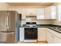 Efficient kitchen with white cabinets, stainless steel appliances, and a sleek gas range for easy cooking at 2536 Lancewood Ln, Lithonia, GA 30058