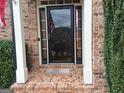 Inviting entryway with brick columns framing the doorway and a glimpse of the home's interior at 107 Heatherwood Trce, Acworth, GA 30101
