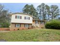 Charming two-story home with brick and vinyl siding, inviting front yard, and traditional architectural details at 203 Greensprings Dr, Palmetto, GA 30268