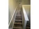 Staircase with new wood look floors and white railings leads to the upper level of the home at 3731 Patti Pkwy, Decatur, GA 30034