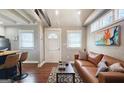 Comfortable living room featuring hardwood floors, a leather couch, and neutral colors at 4657 Elam Church Rd, Forest Park, GA 30297