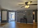 Spacious living room with hardwood floors, neutral gray walls, and an open doorway to the outside at 634 S Jeff Davis Dr, Fayetteville, GA 30215