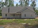 Close-up of new construction home with light-colored siding and a covered front porch at 22638 Salem Church Rd, Metter, GA 30349