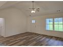 Bright, vaulted living room with new vinyl flooring and large window at 22638 Salem Church Rd, Metter, GA 30349