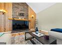 Cozy living room featuring a stone fireplace and sleek glass coffee table at 280 Nutt Dr, Locust Grove, GA 30248