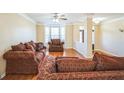 Cozy living room featuring comfortable seating, a bay window, and hardwood floors at 132 Westmont Way, Tyrone, GA 30290