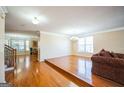 Open-concept living area with hardwood floors and staircase in view at 132 Westmont Way, Tyrone, GA 30290