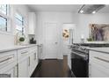 Bright kitchen featuring white cabinets, gold hardware, and stainless steel appliances at 2377 Beecher Sw Rd, Atlanta, GA 30311