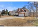 Side view of brick home with well-maintained lawn and landscaping at 3967 Bellingrath Main Nw, Kennesaw, GA 30144