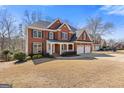 Charming brick home with a manicured lawn and three car garage at 3967 Bellingrath Main Nw, Kennesaw, GA 30144