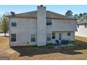 The backyard features a patio area and access to the house via a door, with mature trees nearby at 5864 Sunflower Ct, Ellenwood, GA 30294