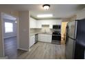 Modern kitchen boasts stainless steel appliances, granite countertops, and white cabinetry at 263 Banberry Se Dr, Atlanta, GA 30315