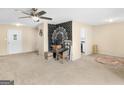 Open-concept living room with carpet, view into a kitchen, and a ceiling fan at 71 Russell Rd, Mcdonough, GA 30252