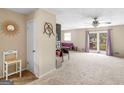 Spacious carpeted living room with adjacent sitting area, view of a patio, and natural light at 71 Russell Rd, Mcdonough, GA 30252
