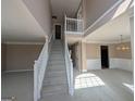 Bright foyer features a staircase and an open floor plan leading to other rooms at 159 Courtneys Ln, Fayetteville, GA 30215