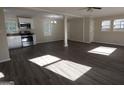 Open-concept living space with hardwood floors adjoining a kitchen with stainless appliances at 3122 Latona Sw Dr, Atlanta, GA 30354