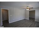 Open-concept living room with new ceiling fan and modern gray floors at 619 Church Nw St, Atlanta, GA 30318