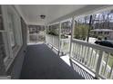 View of the covered front porch featuring a white railing and concrete flooring at 619 Church Nw St, Atlanta, GA 30318