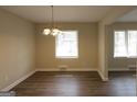 Bright dining room featuring updated flooring, a stylish chandelier, and abundant natural light at 1923 Rosewood Rd, Decatur, GA 30032