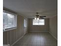 Spacious living room featuring tile floors, wainscoting, natural light and a ceiling fan at 1923 Rosewood Rd, Decatur, GA 30032