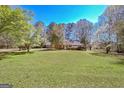 Ranch home with manicured front lawn, complemented by mature trees at 110 Sycamore Bnd, Fayetteville, GA 30214