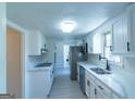 Modern kitchen features white cabinets, stainless steel appliances, and sleek countertops at 2282 Tiffany Ct, Jonesboro, GA 30236