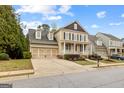 Beautiful exterior of a two-story home with an attached two car garage and a manicured front lawn at 1301 Blue Sky Ct, Peachtree City, GA 30269