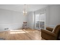 Bright living room features gleaming hardwood floors, large window, and a stylish light fixture at 1593 Brynwood Nw Ct, Acworth, GA 30101