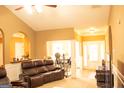 Comfortable living room with leather seating and an open layout flowing into the dining area at 1109 Norsworthy Ml, Hampton, GA 30228