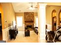 Spacious living room with a cozy brick fireplace, neutral walls, and carpeted floors at 1109 Norsworthy Ml, Hampton, GA 30228