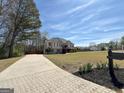 Beautiful residence with a long driveway, showcasing ample yard space and mature trees at 125 Mcintosh Estates Dr, Sharpsburg, GA 30277