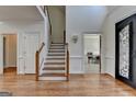 Inviting foyer featuring hardwood floors, staircase, and natural light at 4852 Jacobs Cove Pt, Buford, GA 30519