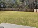 Expansive backyard with a full fence, great for recreation and entertaining at 1126 Old Jackson Rd, Locust Grove, GA 30248