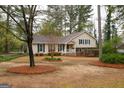 A well-maintained lawn, mature trees and beautiful landscaping surrounds this traditional style home at 35 East Honeysuckle Ln, Carrollton, GA 30116