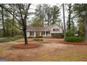 A well-maintained lawn, mature trees and beautiful landscaping surrounds this traditional style home at 35 East Honeysuckle Ln, Carrollton, GA 30116