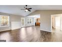 Spacious living room with hardwood floors, fireplace, vaulted ceiling, and large windows for ample natural light at 217 Old Carrollton Rd, Carrollton, GA 30116